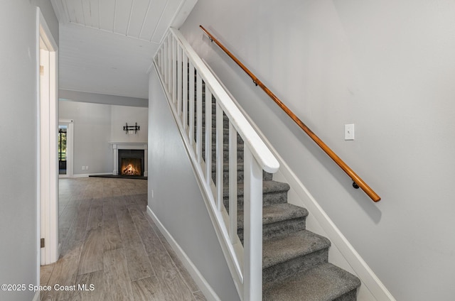 1250 Admiralty Blvd, Rockledge, FL 32955 - stairs with wood finished floors and a warm lit fireplace