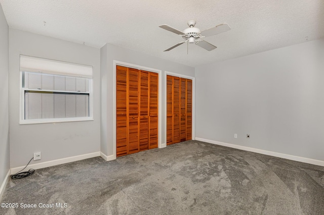 1250 Admiralty Blvd, Rockledge, FL 32955 - unfurnished bedroom featuring multiple closets, carpet flooring, ceiling fan, and a textured ceiling