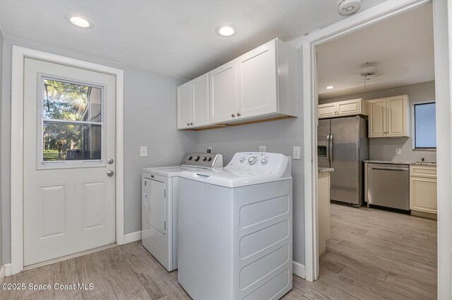 1250 Admiralty Blvd, Rockledge, FL 32955 - laundry room featuring cabinet space, separate washer and dryer, light wood-style floors, and recessed lighting