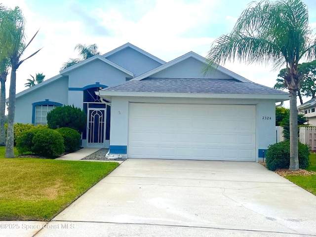 2324 Addington Cir, Rockledge, FL 32955 - single story home featuring stucco siding, a garage, concrete driveway, and a front lawn