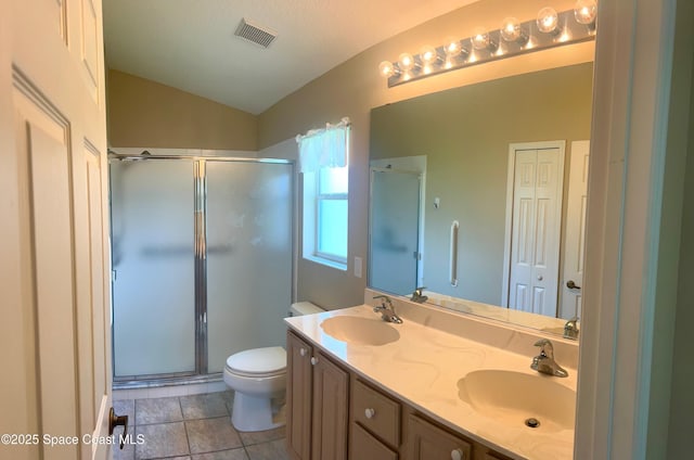 2324 Addington Cir, Rockledge, FL 32955 - bathroom featuring a stall shower, double vanity, vaulted ceiling, and tile patterned flooring