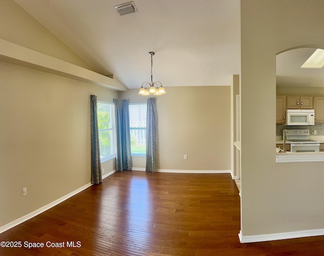2324 Addington Cir, Rockledge, FL 32955 - unfurnished room featuring arched walkways, wood finished floors, vaulted ceiling, and a chandelier