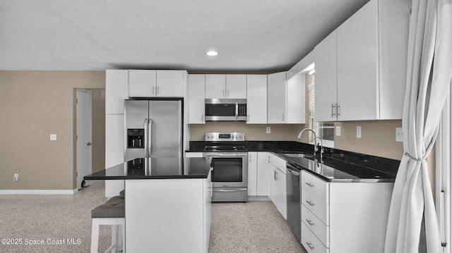 2009 Vaughn St, Titusville, FL 32796 - kitchen featuring stainless steel appliances, dark aggregate flooring, a center island, white cabinets, and recessed lighting