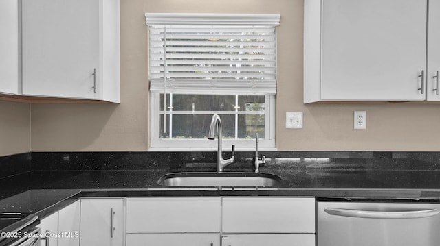 2009 Vaughn St, Titusville, FL 32796 - kitchen with dishwasher, white cabinetry, range, and dark stone countertops