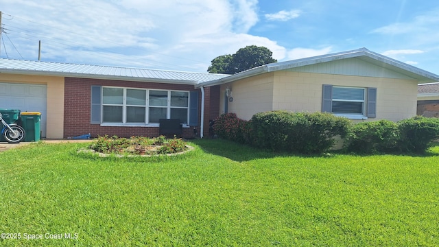 2435 Ricky Rd, Melbourne, FL 32935 - ranch-style home with concrete block siding, a front lawn, a garage, a metal roof, and brick siding