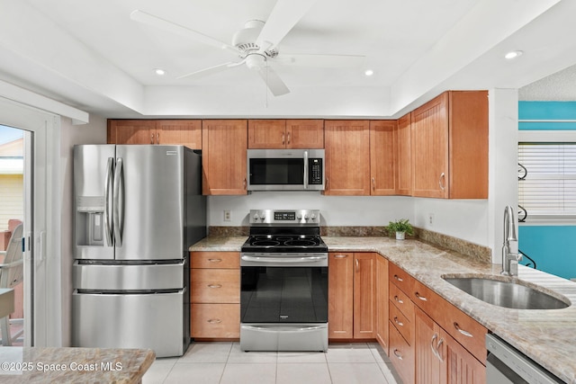 712 Sea Palm Ln, Satellite Beach, FL 32937 - kitchen with stainless steel appliances, light stone countertops, brown cabinets, light tile patterned floors, and recessed lighting