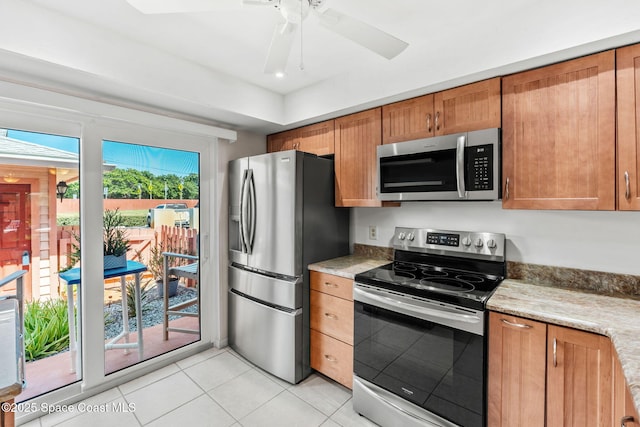 712 Sea Palm Ln, Satellite Beach, FL 32937 - kitchen with appliances with stainless steel finishes, light tile patterned floors, brown cabinets, and light countertops