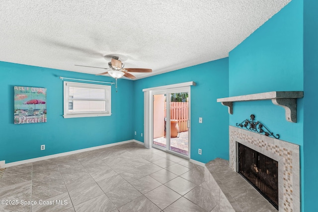 712 Sea Palm Ln, Satellite Beach, FL 32937 - unfurnished living room featuring plenty of natural light, a tiled fireplace, a ceiling fan, and a textured ceiling