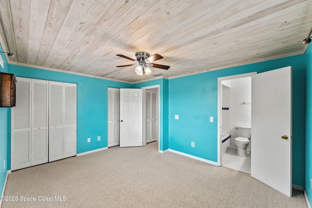 712 Sea Palm Ln, Satellite Beach, FL 32937 - unfurnished bedroom with wooden ceiling, multiple closets, carpet floors, ensuite bath, and a ceiling fan