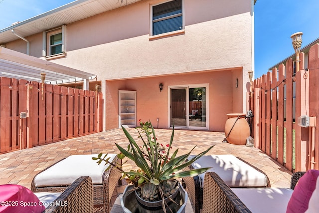 712 Sea Palm Ln, Satellite Beach, FL 32937 - rear view of house with stucco siding and a patio