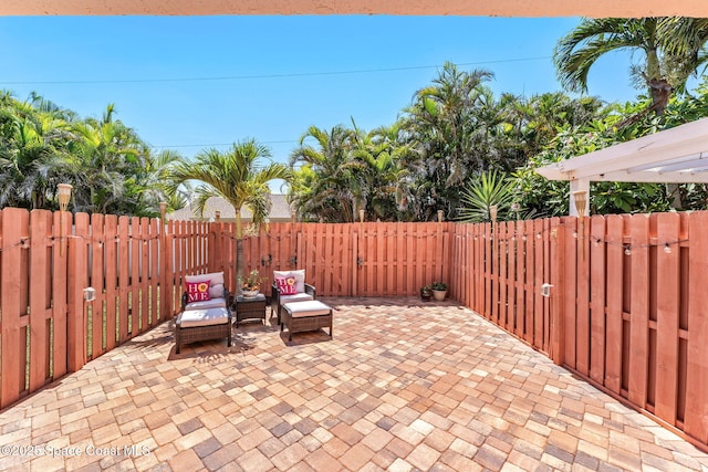 712 Sea Palm Ln, Satellite Beach, FL 32937 - fenced backyard featuring a patio and an outdoor hangout area