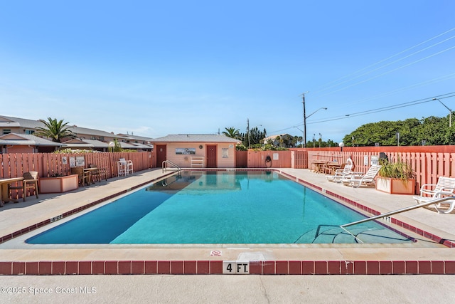 712 Sea Palm Ln, Satellite Beach, FL 32937 - community pool featuring a patio area and a fenced backyard