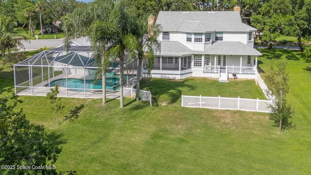 2123 Royal Oaks Dr, Rockledge, FL 32955 - rear view of property with an outdoor pool, roof with shingles, a patio area, a lanai, and a chimney