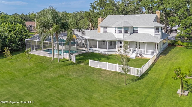 2123 Royal Oaks Dr, Rockledge, FL 32955 - rear view of house with a chimney, an outdoor pool, a fenced backyard, and roof with shingles