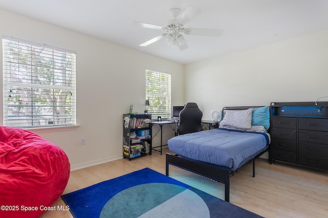 2123 Royal Oaks Dr, Rockledge, FL 32955 - bedroom with wood finished floors, a desk, and a ceiling fan