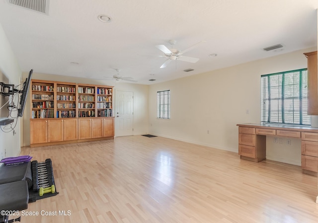 2123 Royal Oaks Dr, Rockledge, FL 32955 - unfurnished living room with built in study area, light wood-style floors, ceiling fan, and recessed lighting
