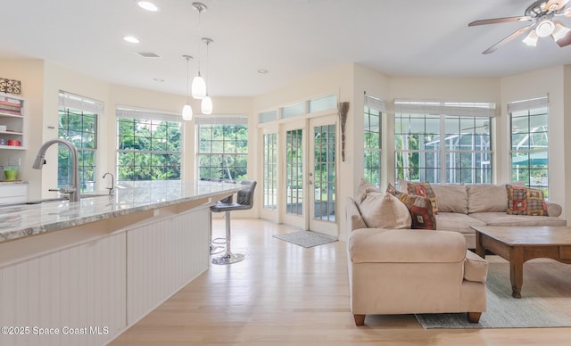 2123 Royal Oaks Dr, Rockledge, FL 32955 - living area featuring light wood-style flooring, recessed lighting, ceiling fan, and french doors