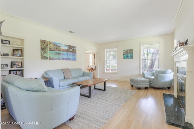 2123 Royal Oaks Dr, Rockledge, FL 32955 - living area with wood finished floors, a premium fireplace, ornamental molding, and built in shelves