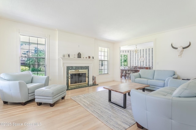 2123 Royal Oaks Dr, Rockledge, FL 32955 - living room with light wood finished floors, a chandelier, and a premium fireplace