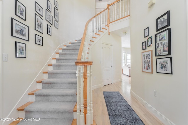 2123 Royal Oaks Dr, Rockledge, FL 32955 - staircase featuring wood finished floors and a high ceiling