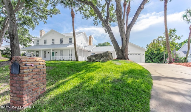 2123 Royal Oaks Dr, Rockledge, FL 32955 - view of front of home featuring a chimney, covered porch, driveway, and a front lawn