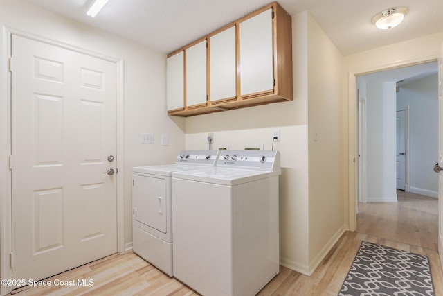 2123 Royal Oaks Dr, Rockledge, FL 32955 - laundry area with separate washer and dryer, light wood finished floors, and cabinet space
