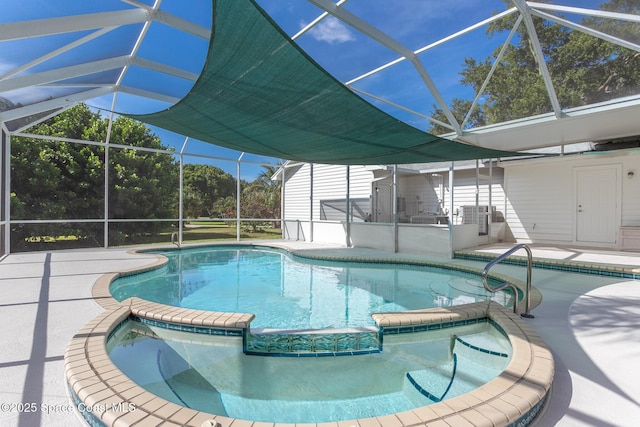 2123 Royal Oaks Dr, Rockledge, FL 32955 - view of swimming pool featuring a pool with connected hot tub, glass enclosure, and a patio