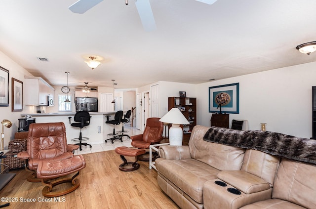 112 Plover Ln Unit 6-33, Rockledge, FL 32955 - living room with ceiling fan and light wood finished floors