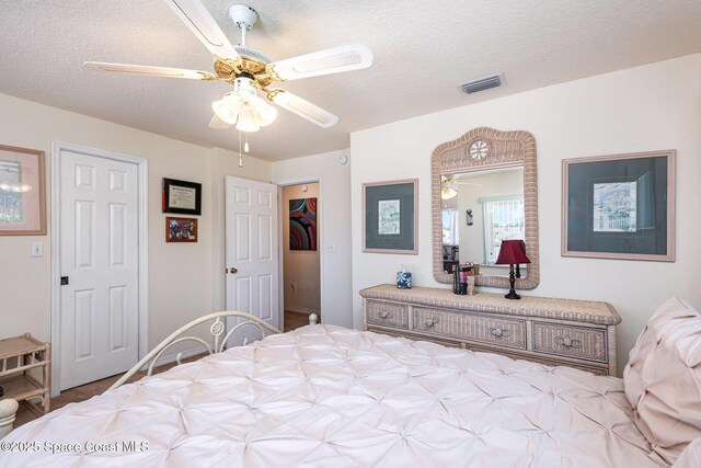 112 Plover Ln Unit 6-33, Rockledge, FL 32955 - carpeted bedroom with a textured ceiling and a ceiling fan
