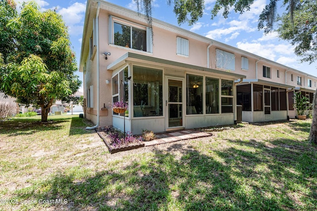 112 Plover Ln Unit 6-33, Rockledge, FL 32955 - back of property featuring a sunroom, stucco siding, and a yard