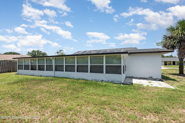 1245 Arlington Cir, Merritt Island, FL 32952 - rear view of house with a sunroom and concrete block siding