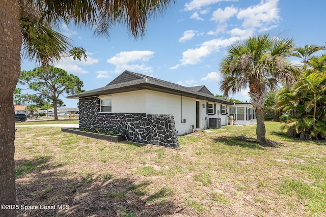 1245 Arlington Cir, Merritt Island, FL 32952 - view of side of property featuring a lawn and a central AC unit