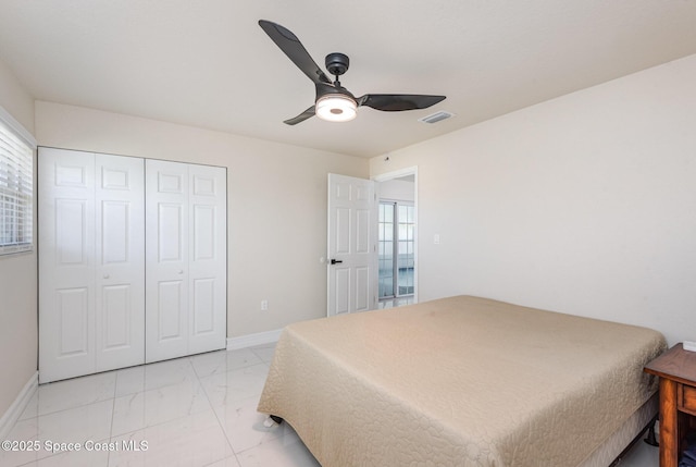 1245 Arlington Cir, Merritt Island, FL 32952 - bedroom with multiple windows, light marble finish flooring, a closet, and ceiling fan