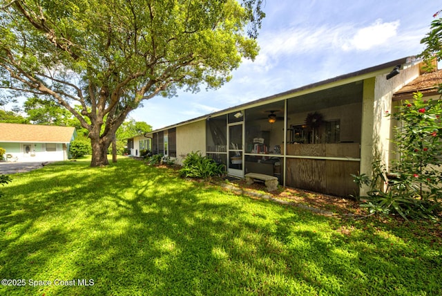 1240 Cheney Hwy Unit F, Titusville, FL 32780 - view of green lawn featuring a sunroom and a ceiling fan