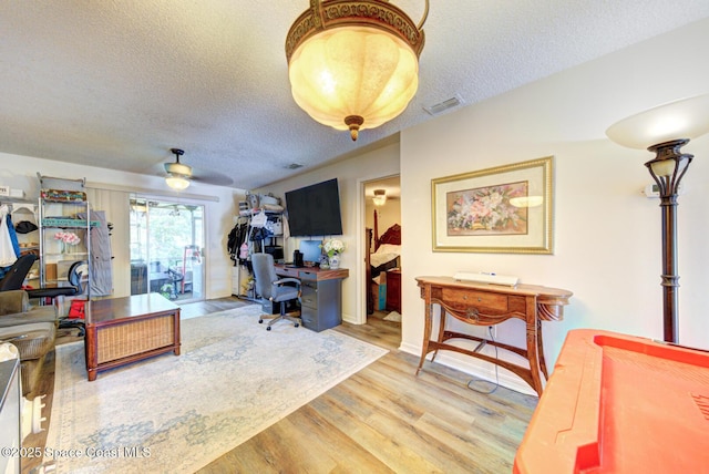 1240 Cheney Hwy Unit F, Titusville, FL 32780 - office space featuring wood finished floors, a textured ceiling, and ceiling fan