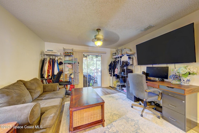 1240 Cheney Hwy Unit F, Titusville, FL 32780 - office with a ceiling fan, wood finished floors, and a textured ceiling