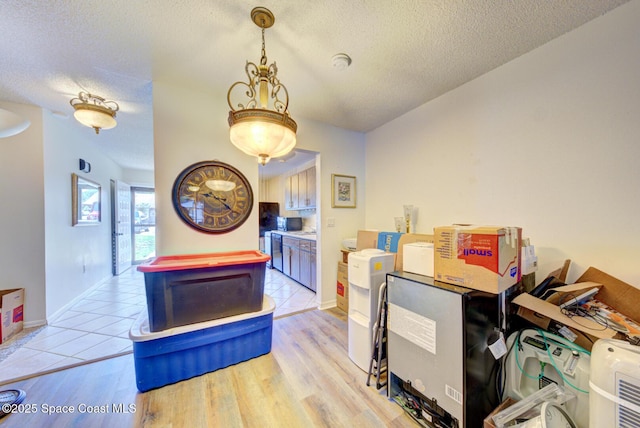 1240 Cheney Hwy Unit F, Titusville, FL 32780 - dining room with a textured ceiling and light wood-style floors