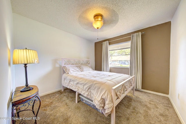 1240 Cheney Hwy Unit F, Titusville, FL 32780 - carpeted bedroom featuring a textured ceiling and a ceiling fan