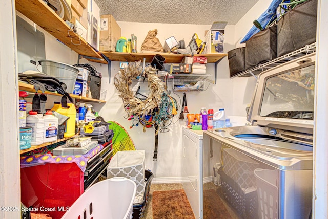 1240 Cheney Hwy Unit F, Titusville, FL 32780 - laundry room with washing machine and clothes dryer and a textured ceiling