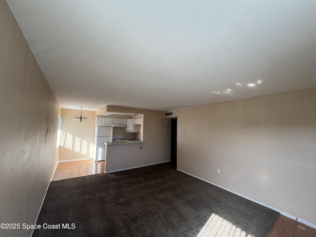 800 N Fiske Blvd Unit 613, Cocoa, FL 32922 - unfurnished living room with dark carpet and a chandelier