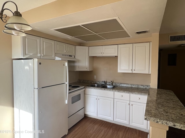 800 N Fiske Blvd Unit 613, Cocoa, FL 32922 - kitchen with white appliances, under cabinet range hood, white cabinetry, and a peninsula
