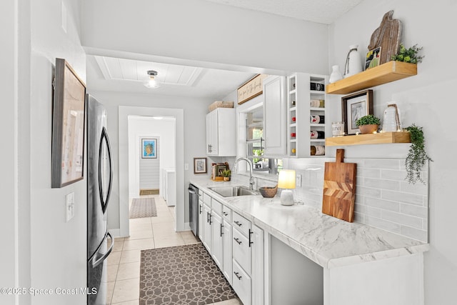3127 Marshall Dr, Melbourne, FL 32901 - kitchen with open shelves, stainless steel appliances, backsplash, light countertops, and light tile patterned floors