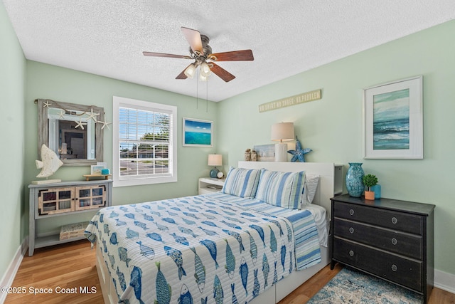 3127 Marshall Dr, Melbourne, FL 32901 - bedroom featuring wood finished floors, a textured ceiling, and ceiling fan