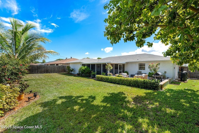 3127 Marshall Dr, Melbourne, FL 32901 - back of property featuring a sunroom, a fenced backyard, stucco siding, and a patio area