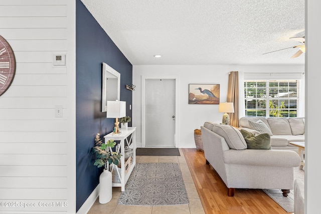 3127 Marshall Dr, Melbourne, FL 32901 - living room with a textured ceiling, a ceiling fan, and light wood-type flooring