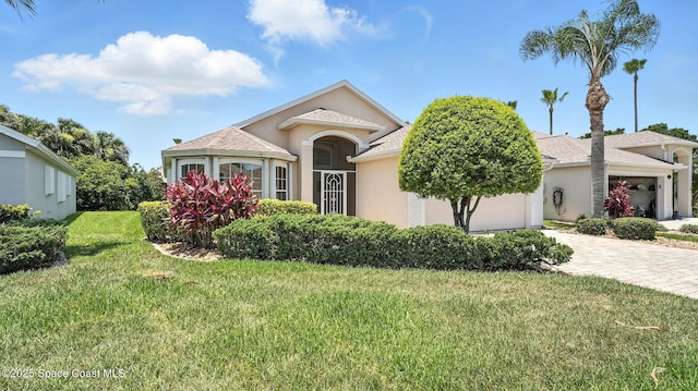 7927 Citrus Creek Dr, Melbourne, FL 32940 - view of front of property featuring driveway, a garage, stucco siding, and a front yard