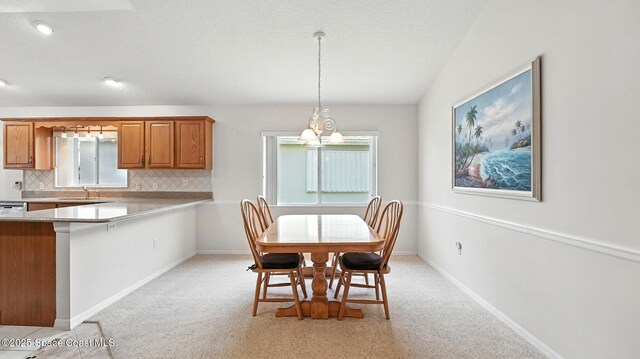 7927 Citrus Creek Dr, Melbourne, FL 32940 - dining space featuring a chandelier and light carpet