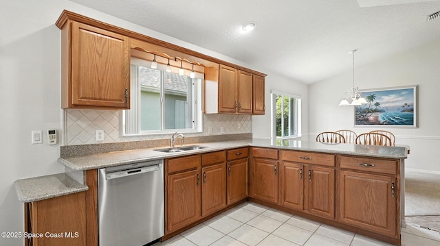 7927 Citrus Creek Dr, Melbourne, FL 32940 - kitchen featuring stainless steel dishwasher, a peninsula, brown cabinets, backsplash, and lofted ceiling