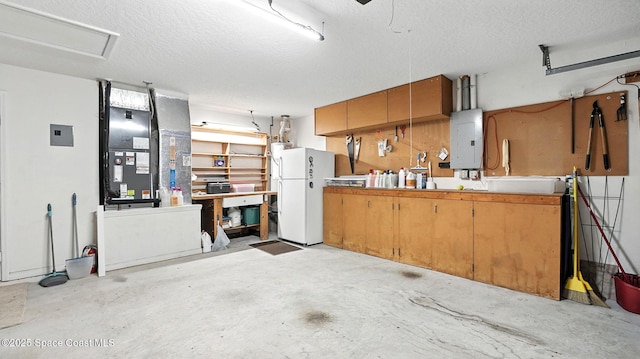 7927 Citrus Creek Dr, Melbourne, FL 32940 - garage featuring electric panel, freestanding refrigerator, and a workshop area