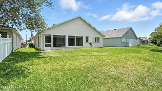 7927 Citrus Creek Dr, Melbourne, FL 32940 - rear view of property with stucco siding and a lawn